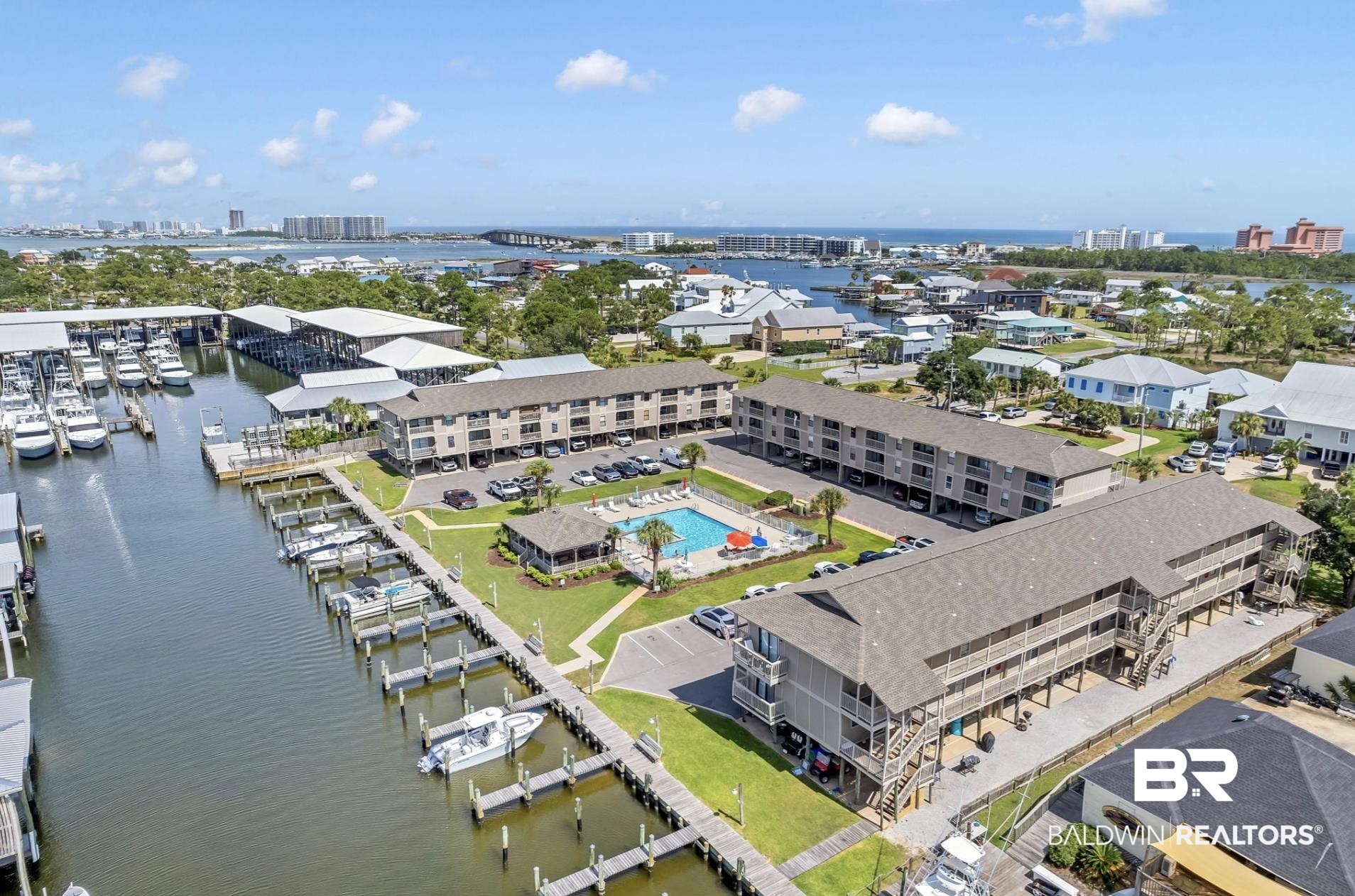 26913 Marina Road, Unit 214 Orange Beach, AL 36561 - Photo 1 of 1 View of urban area featuring a large body of water and numerous boat docks