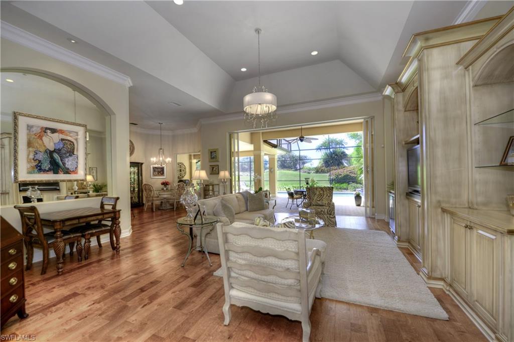 a very nice looking living room with a large window and wooden floor