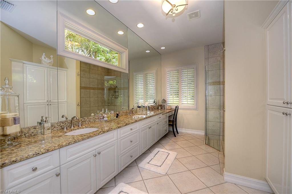 3274 Sedge Place Naples, FL 34105 - Photo 11 of 24 a large bathroom with a double vanity sink and a mirror