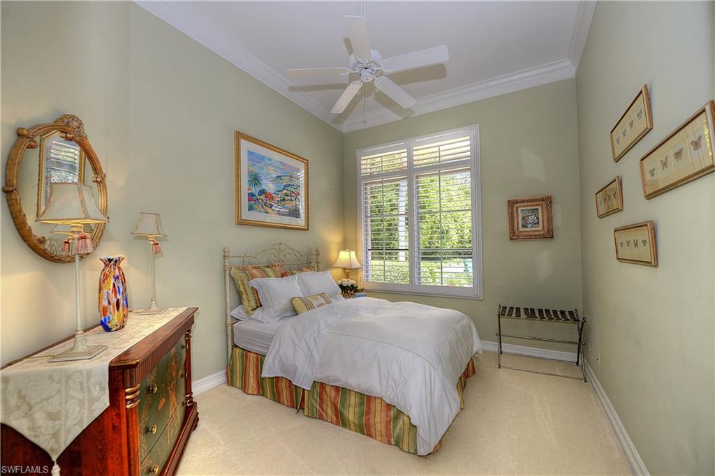 3274 Sedge Place Naples, FL 34105 - Photo 14 of 24 a bedroom with a bed a window and a mirror