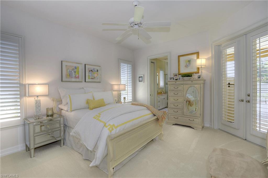 3274 Sedge Place Naples, FL 34105 - Photo 15 of 24 a spacious bedroom with a bed and a chandelier
