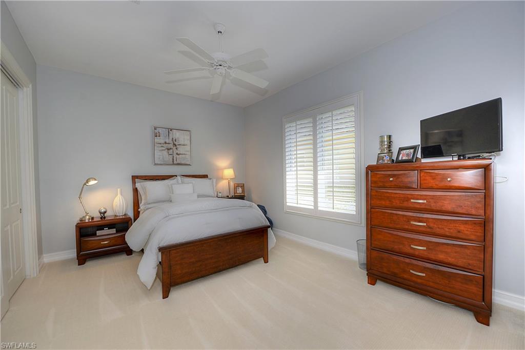 3274 Sedge Place Naples, FL 34105 - Photo 17 of 24 a bedroom with a bed and flat screen tv