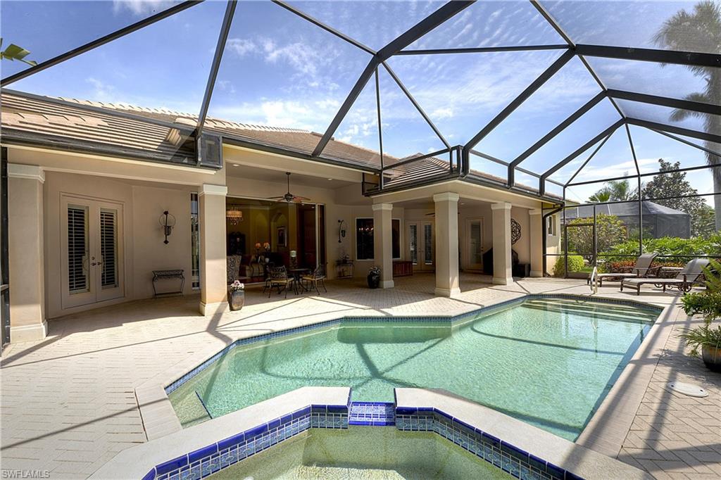 3274 Sedge Place Naples, FL 34105 - Photo 20 of 24 a view of a patio with a table and chairs under an umbrella