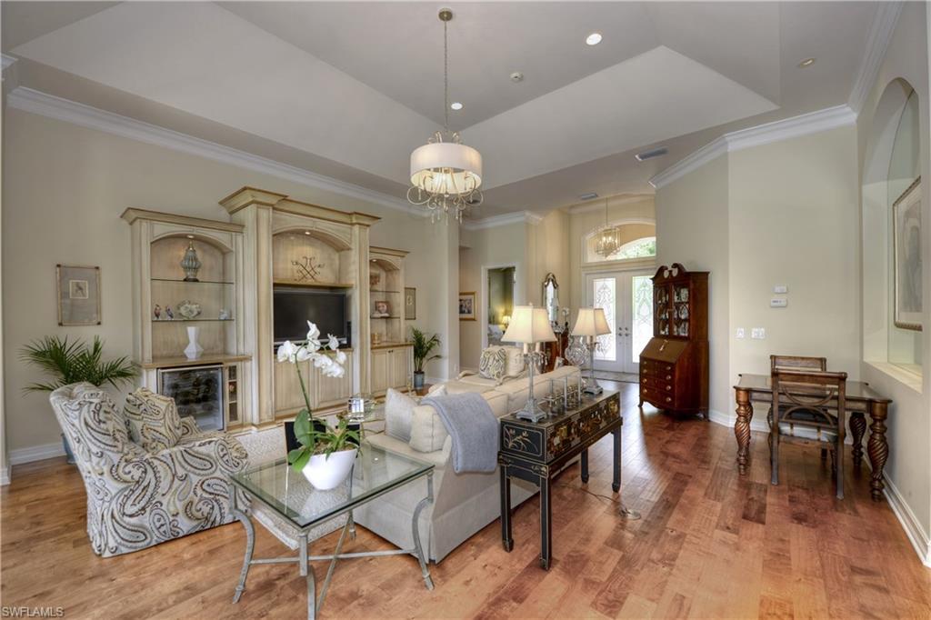 3274 Sedge Place Naples, FL 34105 - Photo 2 of 24 a view of a dining room with furniture wooden floor and chandelier