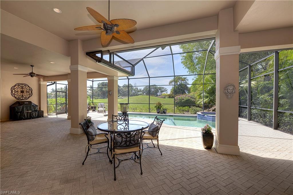 3274 Sedge Place Naples, FL 34105 - Photo 22 of 24 a dining room with furniture and a floor to ceiling window