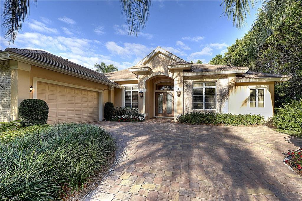 3274 Sedge Place Naples, FL 34105 - Photo 23 of 24 a front view of a house with a yard
