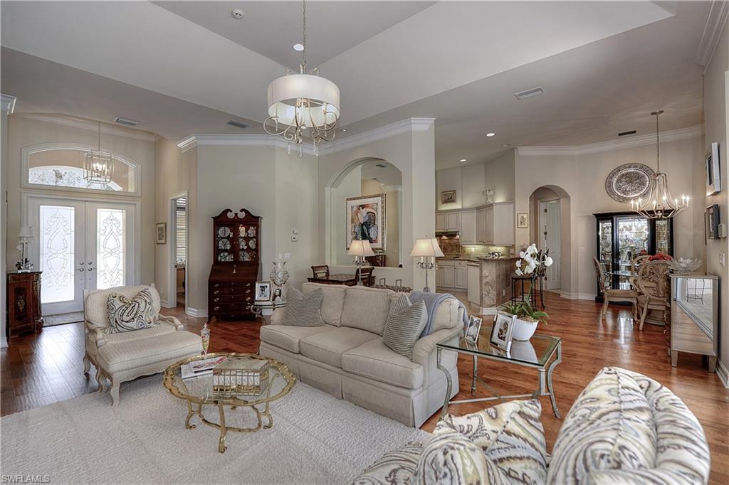 3274 Sedge Place Naples, FL 34105 - Photo 4 of 24 a living room with furniture and a chandelier