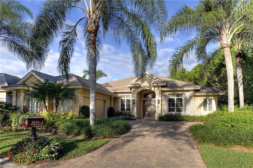 3274 Sedge Place Naples, FL 34105 - Photo 5 of 24 a front view of a house with a yard