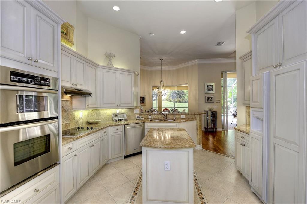 3274 Sedge Place Naples, FL 34105 - Photo 8 of 24 a kitchen with refrigerator and cabinets