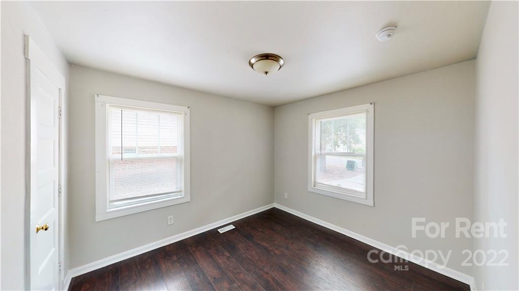 825 Rodey Avenue, Unit 1 Charlotte, NC 28206 - Photo 14 of 15 a view of an empty room with wooden floor and a window