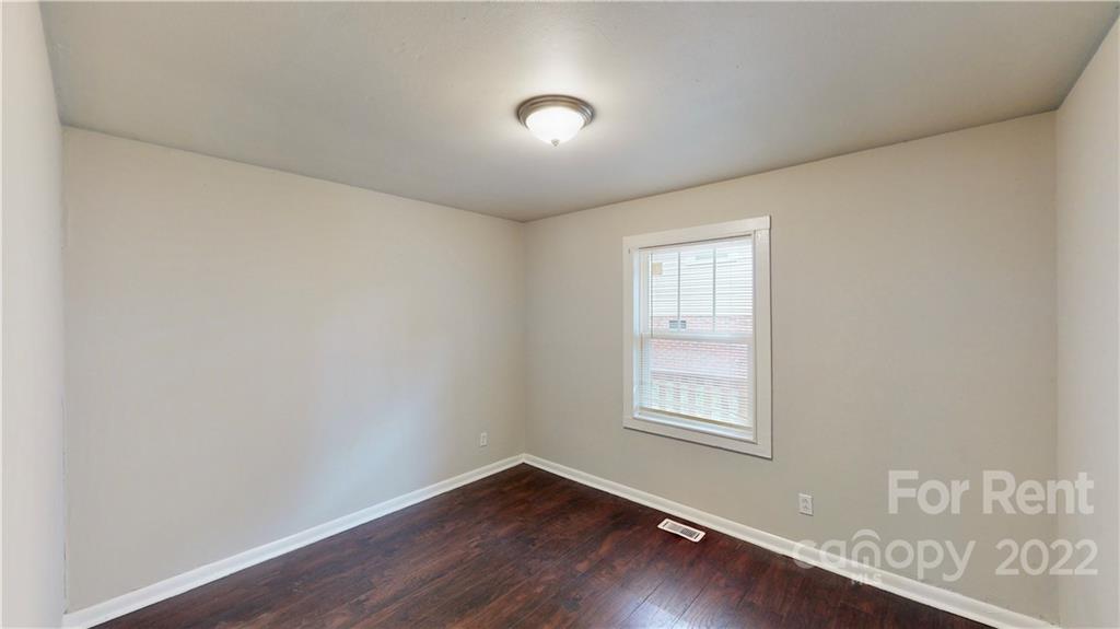 825 Rodey Avenue, Unit 1 Charlotte, NC 28206 - Photo 15 of 15 an empty room with wooden floor and windows
