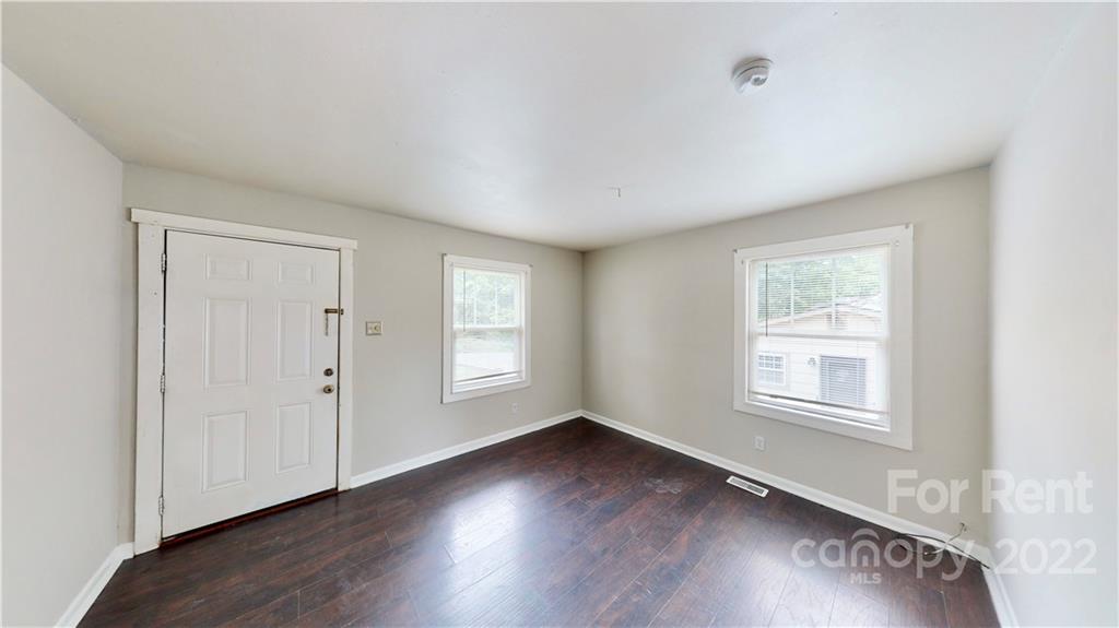 825 Rodey Avenue, Unit 1 Charlotte, NC 28206 - Photo 2 of 15 a view of an empty room with wooden floor and a window