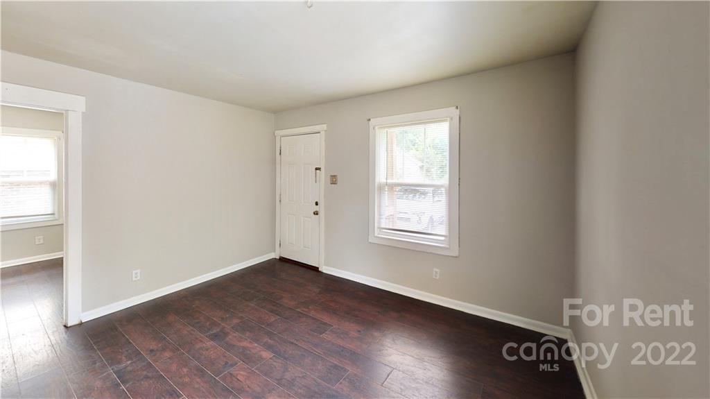 825 Rodey Avenue, Unit 1 Charlotte, NC 28206 - Photo 3 of 15 an empty room with wooden floor and windows