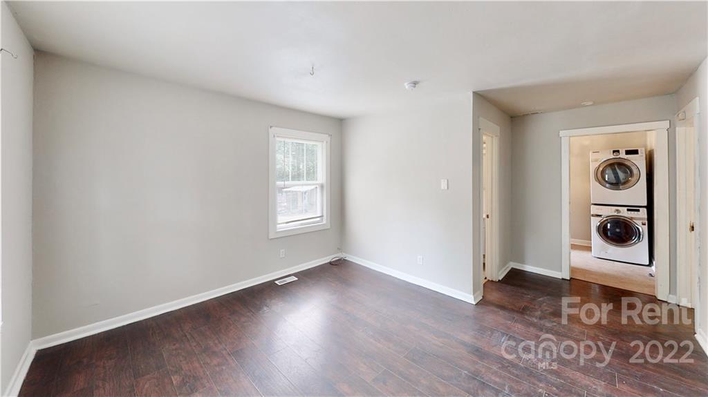 825 Rodey Avenue, Unit 1 Charlotte, NC 28206 - Photo 5 of 15 an empty room with wooden floor closet and windows