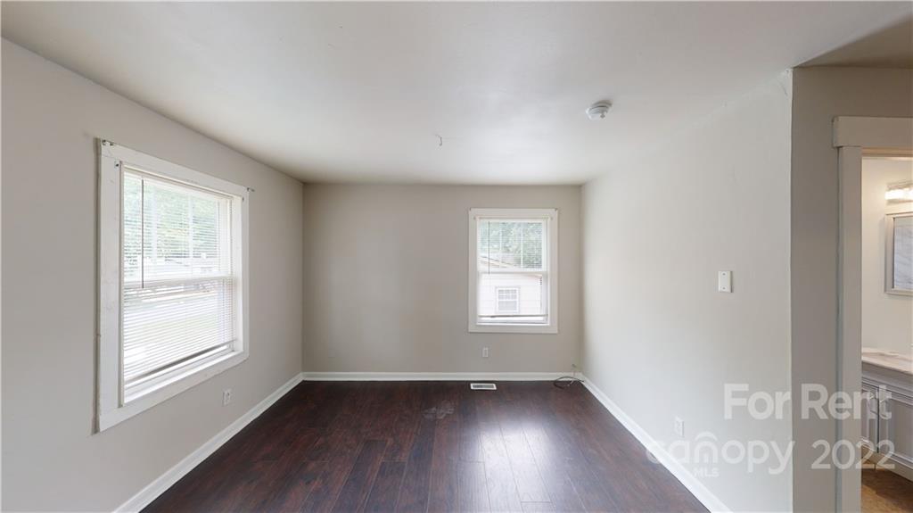 825 Rodey Avenue, Unit 1 Charlotte, NC 28206 - Photo 6 of 15 a view of an empty room with wooden floor and a window
