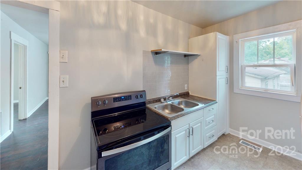 825 Rodey Avenue, Unit 1 Charlotte, NC 28206 - Photo 8 of 15 a kitchen with a stove and a microwave