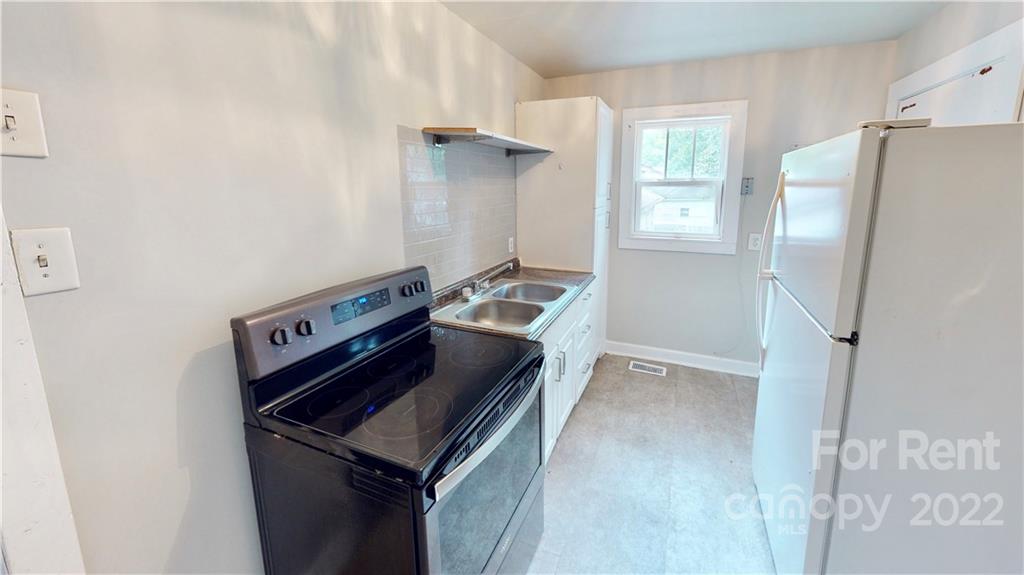 825 Rodey Avenue, Unit 1 Charlotte, NC 28206 - Photo 9 of 15 a kitchen with a refrigerator and a stove