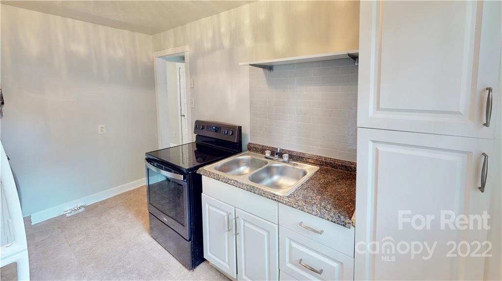 825 Rodey Avenue, Unit 1 Charlotte, NC 28206 - Photo 10 of 15 a bathroom with a granite countertop sink and a granite