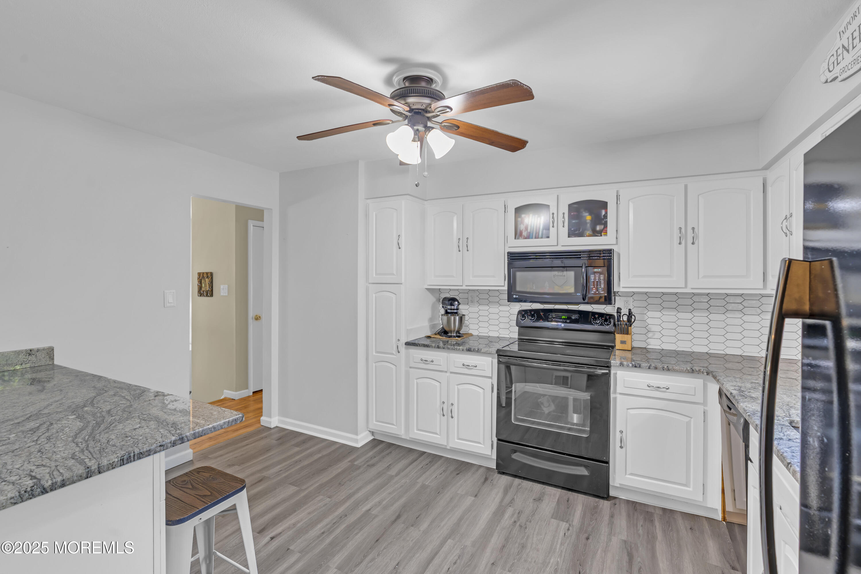 910 Woodlane Road Jackson, NJ 08527 - Photo 13 of 36 a kitchen with granite countertop a stove a sink and a refrigerator