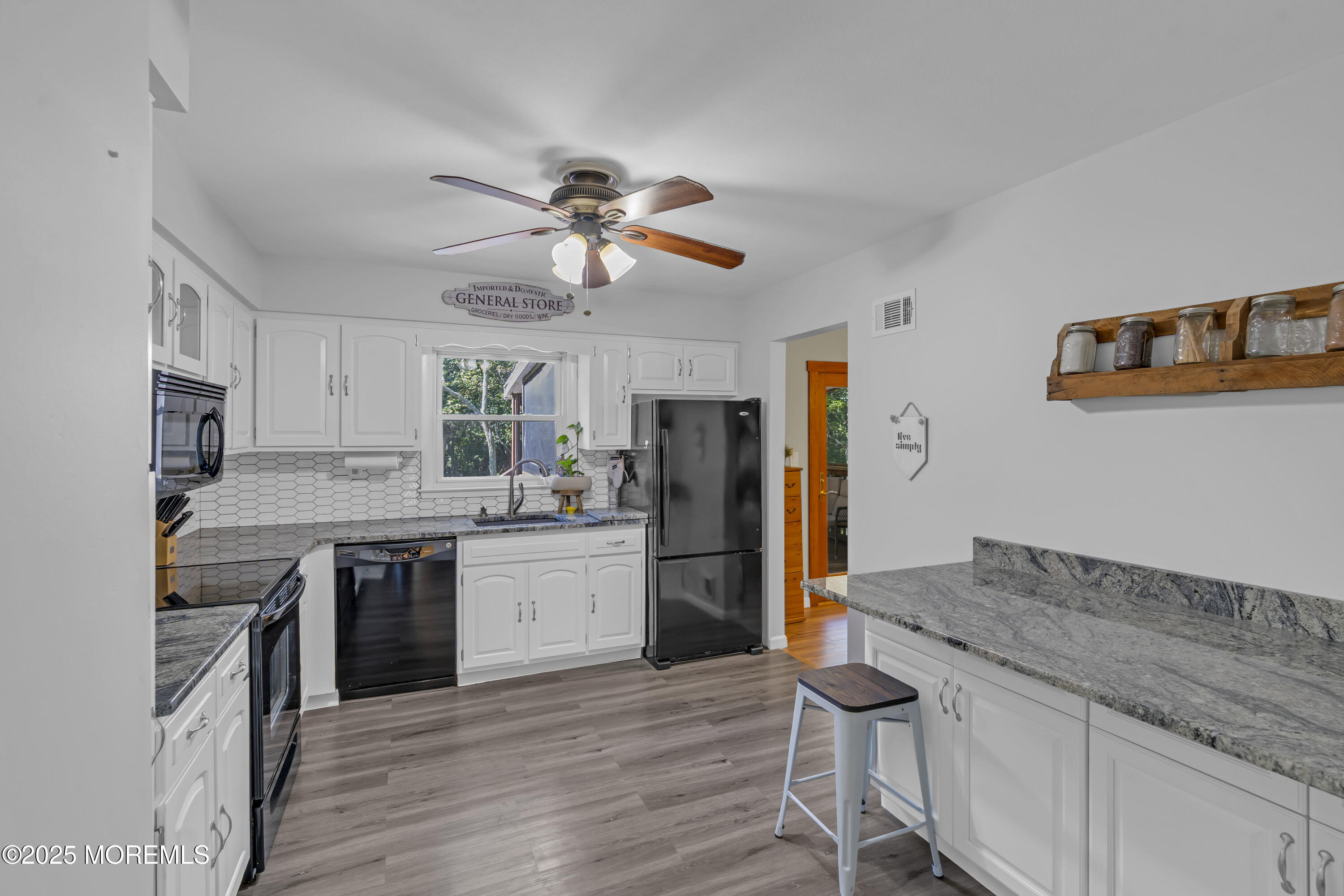 910 Woodlane Road Jackson, NJ 08527 - Photo 14 of 36 a kitchen with granite countertop a stove a sink and a refrigerator