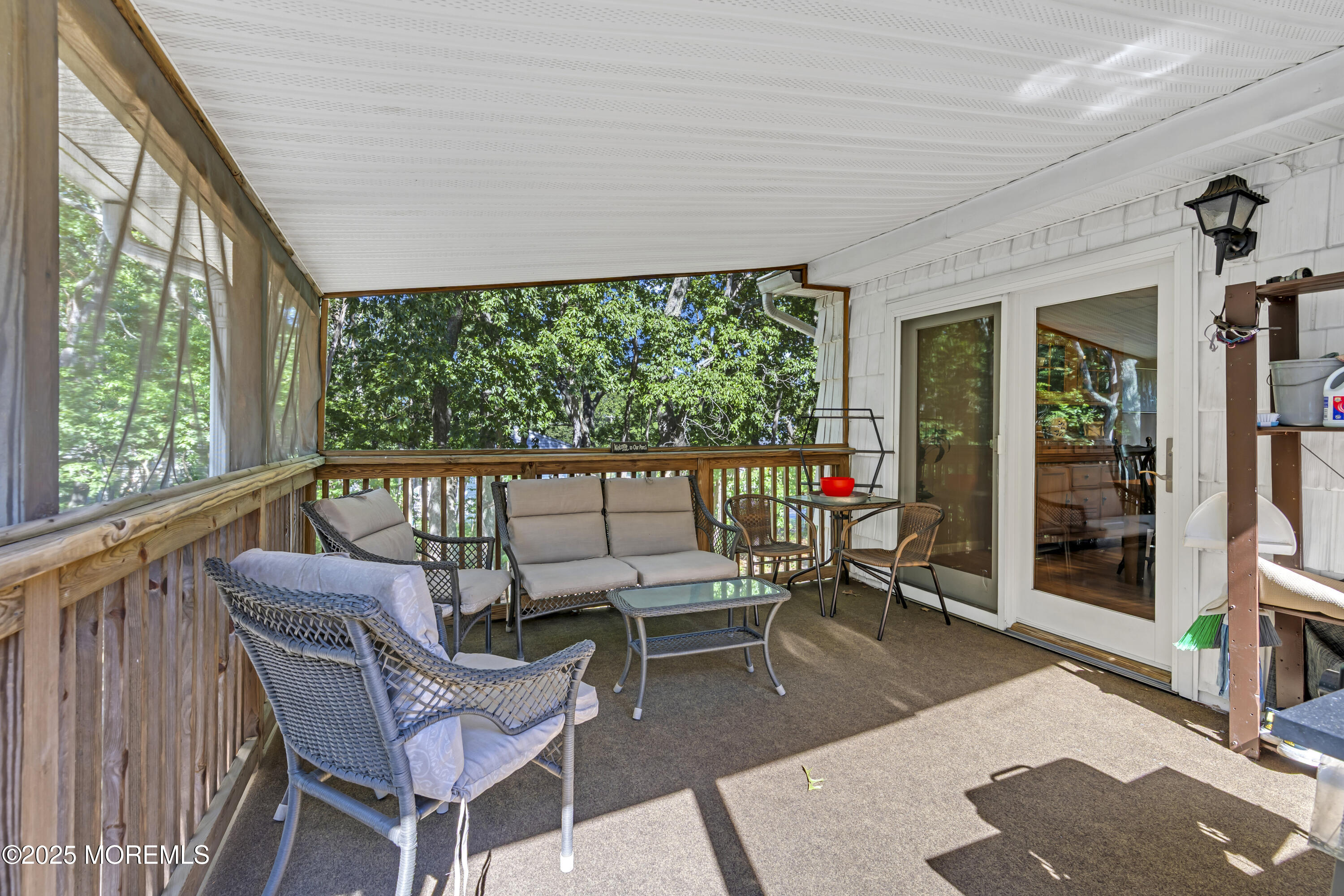 910 Woodlane Road Jackson, NJ 08527 - Photo 18 of 36 a living room with furniture and a floor to ceiling window