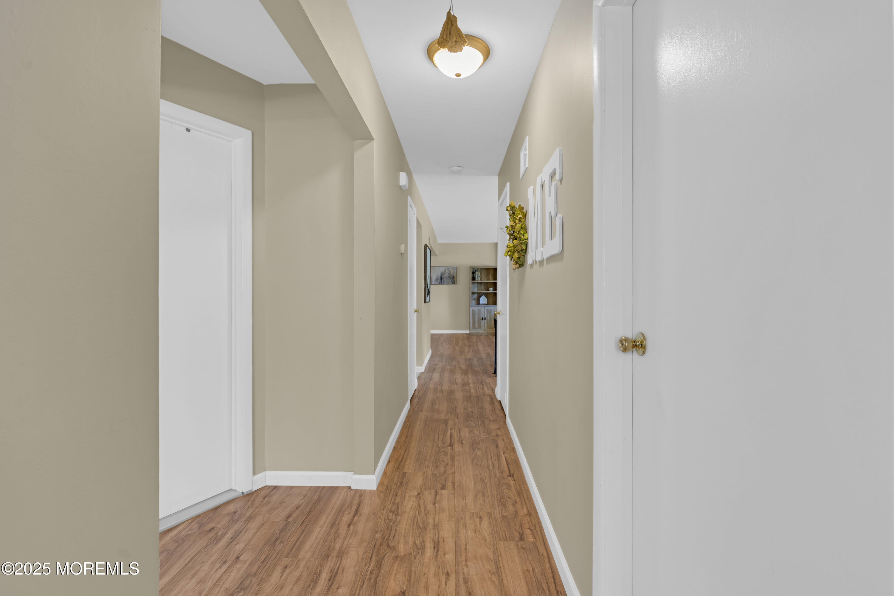 910 Woodlane Road Jackson, NJ 08527 - Photo 19 of 36 a view of a hallway with wooden floor and staircase
