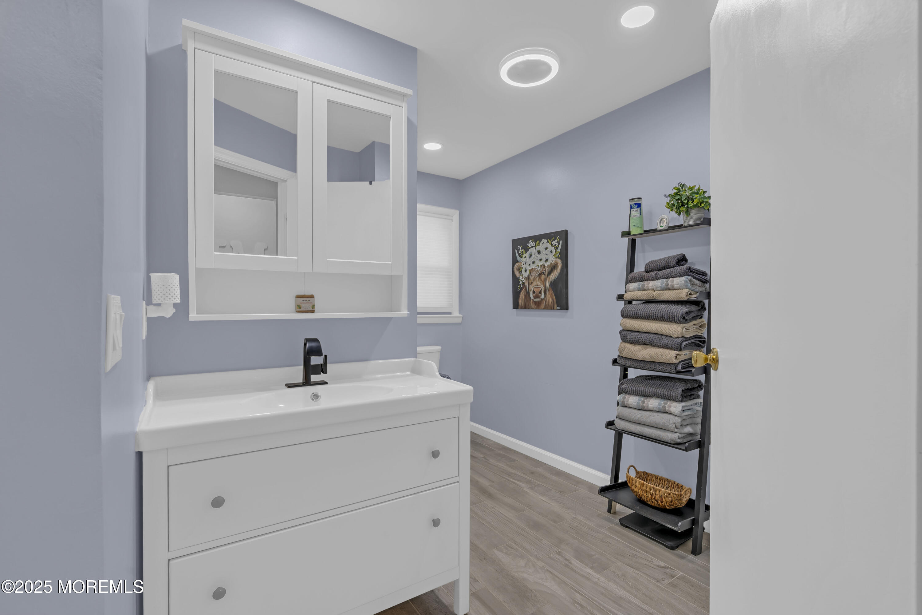 910 Woodlane Road Jackson, NJ 08527 - Photo 20 of 36 a bathroom with a sink and mirror