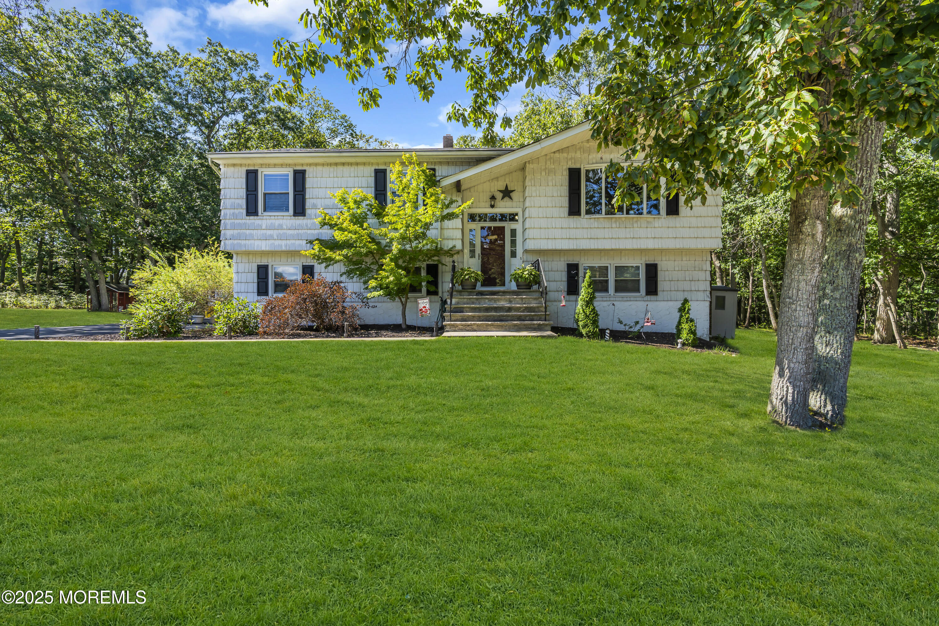 910 Woodlane Road Jackson, NJ 08527 - Photo 2 of 36 a front view of a house with a garden and yard