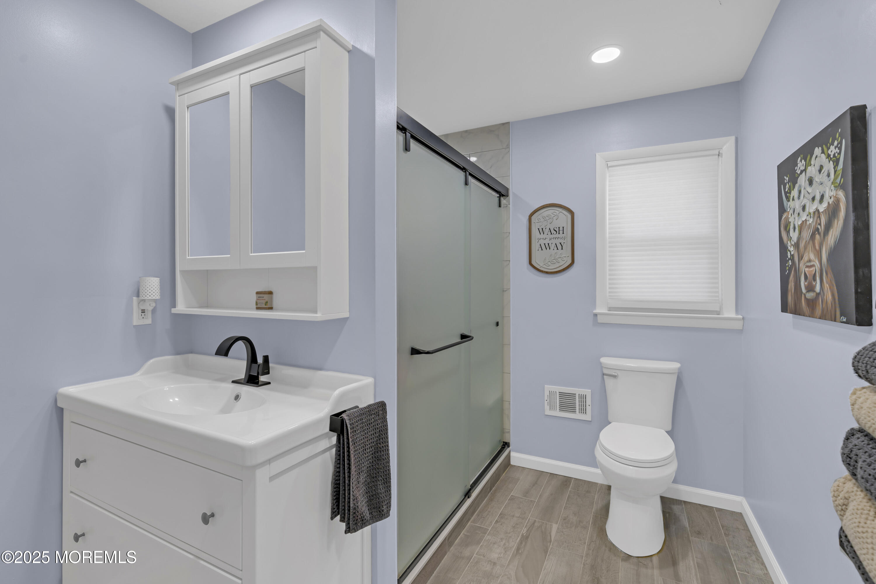 910 Woodlane Road Jackson, NJ 08527 - Photo 21 of 36 a bathroom with a toilet sink and mirror