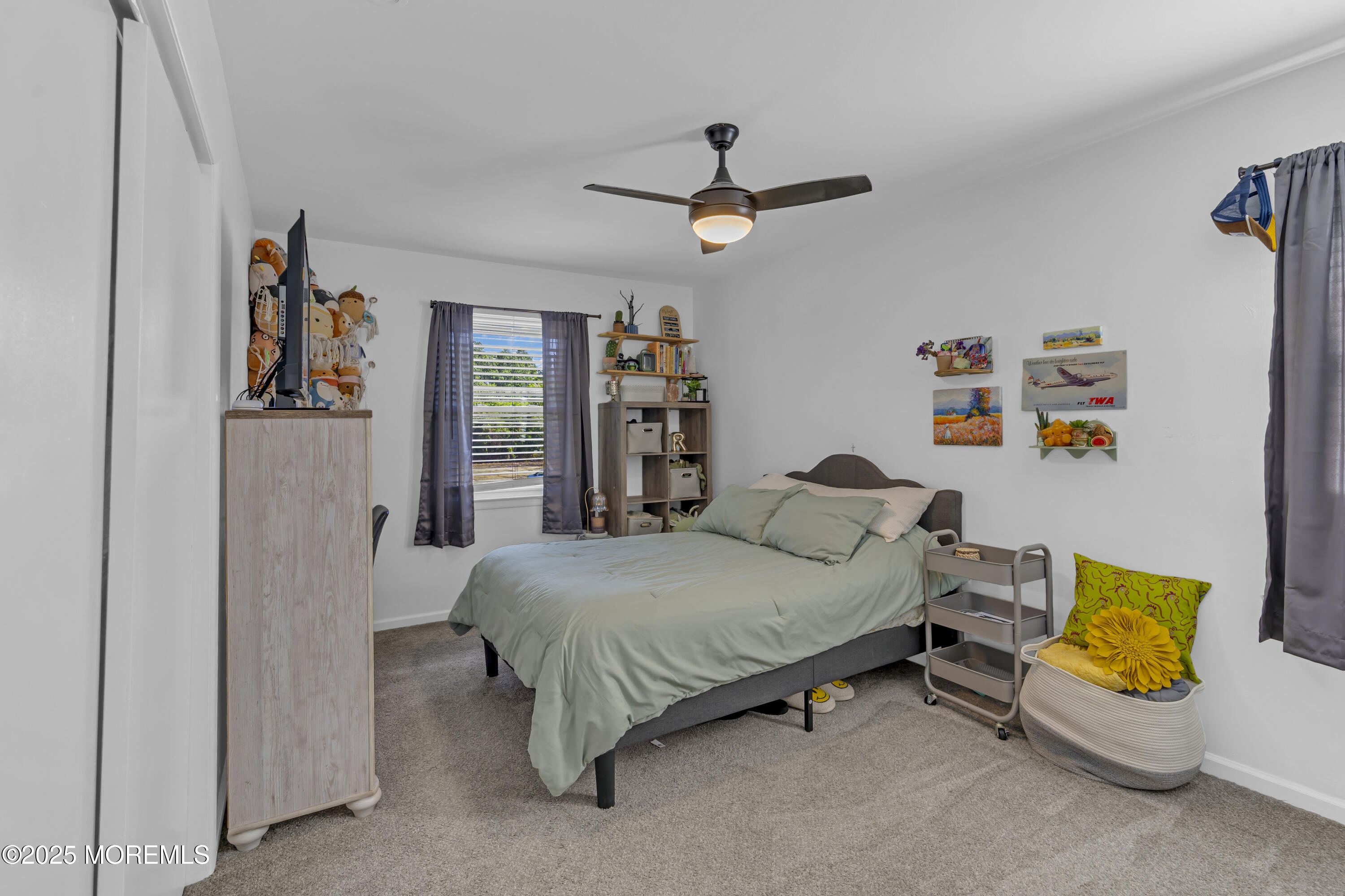 910 Woodlane Road Jackson, NJ 08527 - Photo 25 of 36 a bedroom with a bed and a chandelier