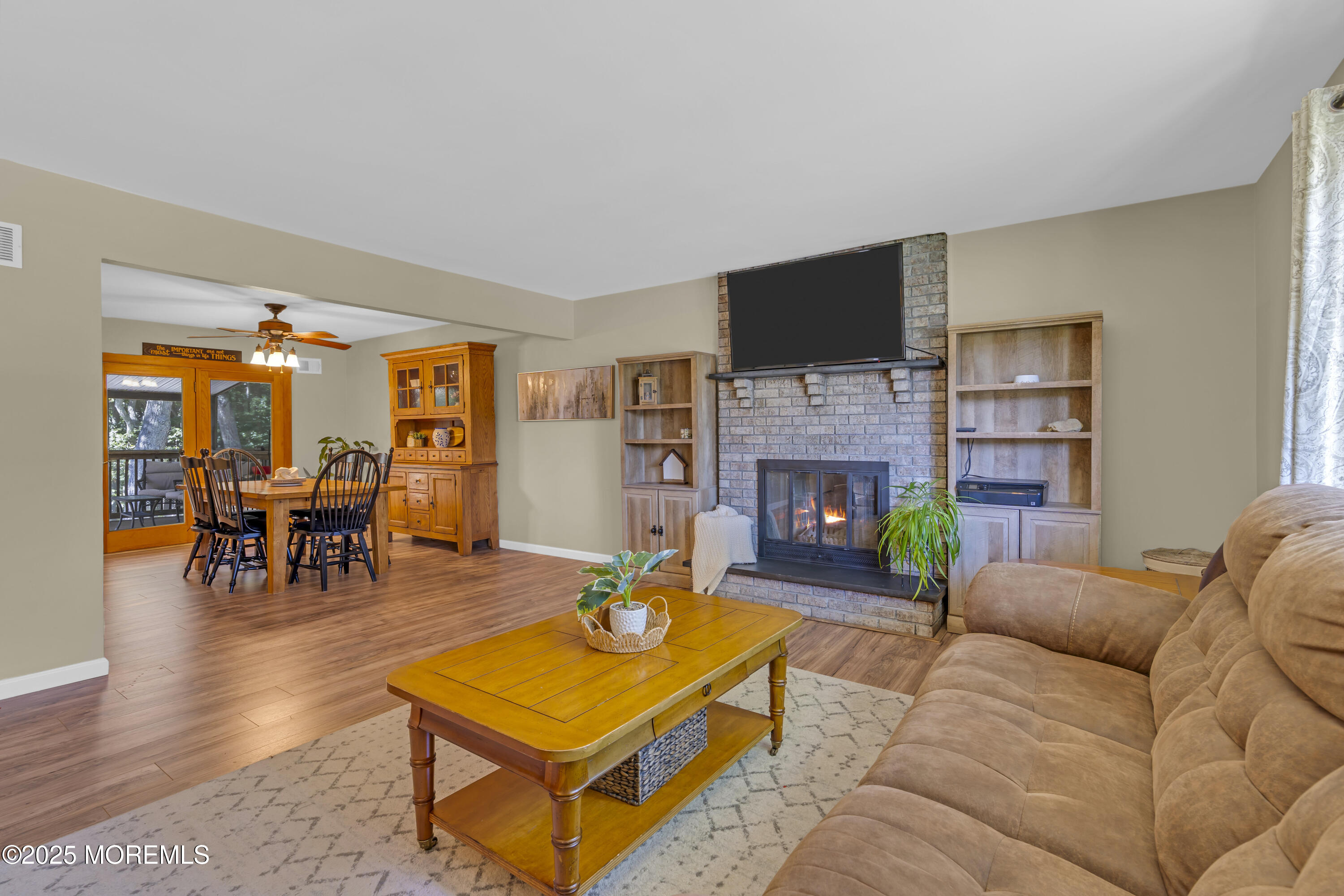 910 Woodlane Road Jackson, NJ 08527 - Photo 8 of 36 a living room with furniture a flat screen tv and a fireplace