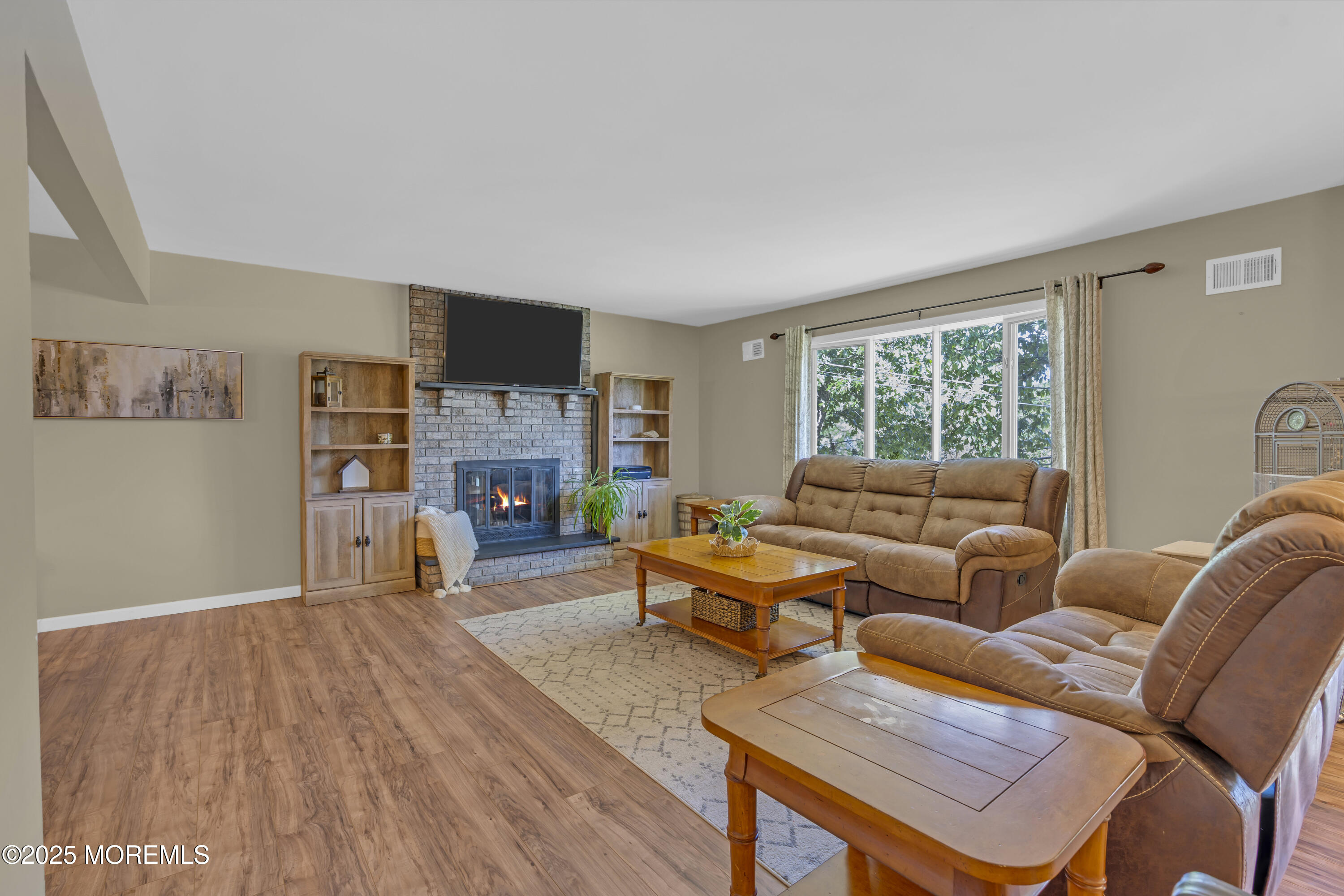 910 Woodlane Road Jackson, NJ 08527 - Photo 9 of 36 a living room with furniture and a fireplace
