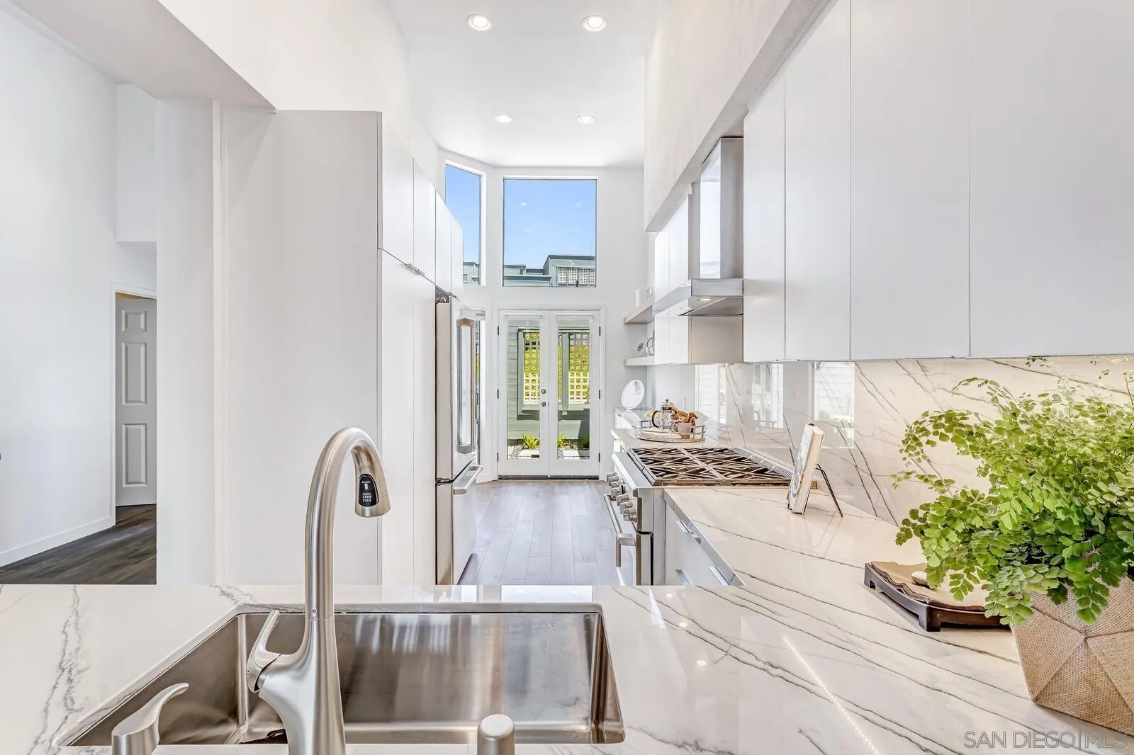 a kitchen with stainless steel appliances kitchen island granite countertop a stove a sink and a refrigerator