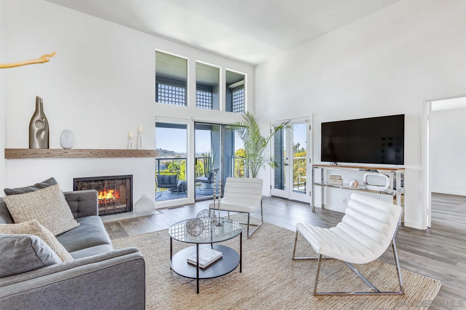 1031 Reliance Way Del Mar, CA 92014 - Photo 11 of 33 a living room with furniture a flat screen tv and a fireplace