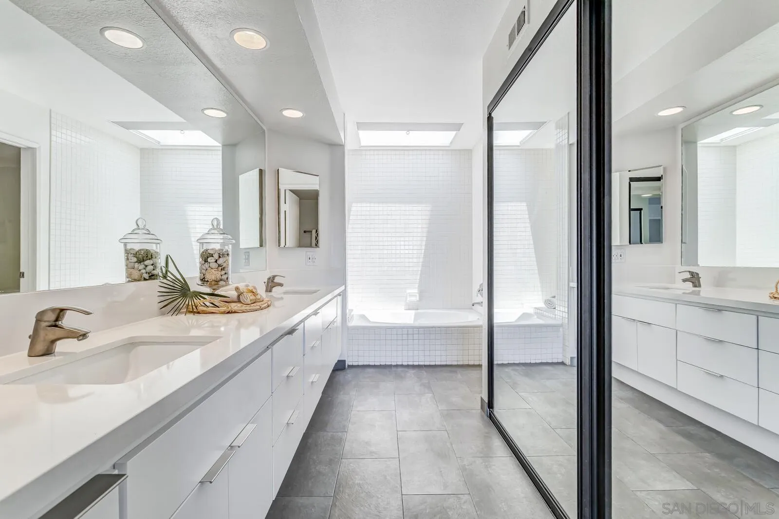 1031 Reliance Way Del Mar, CA 92014 - Photo 15 of 33 a bathroom with a double vanity sink and a mirror