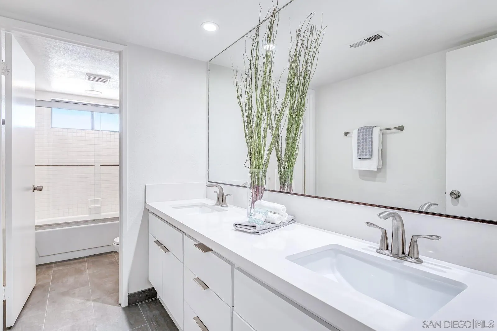 1031 Reliance Way Del Mar, CA 92014 - Photo 20 of 33 a bathroom with a double vanity sink and a mirror