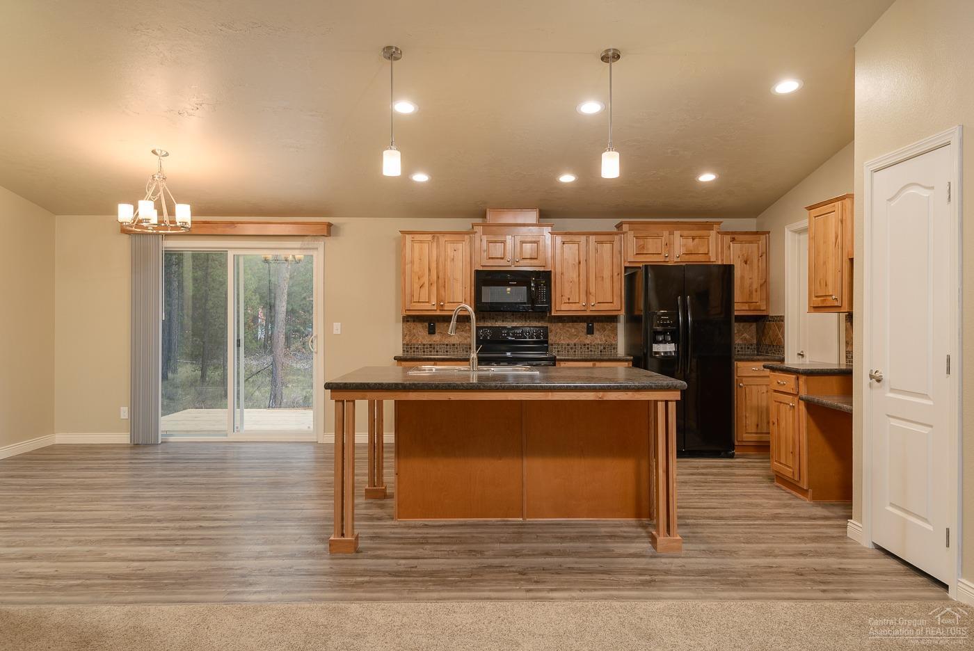 17237 Jacinto Road Bend, OR 97707 - Photo 14 of 20 a view of a kitchen with stainless steel appliances granite countertop a stove and a refrigerator