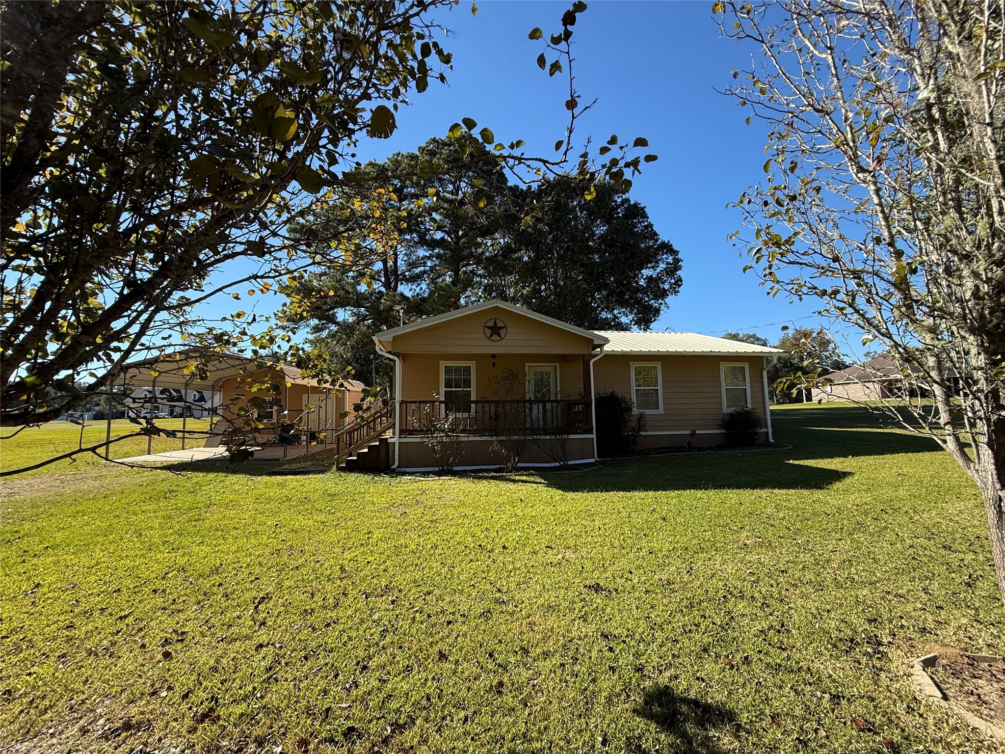 211 North Frances Avenue Shepherd, TX 77371 - Photo 2 of 11 a front view of house with yard and trees in the background