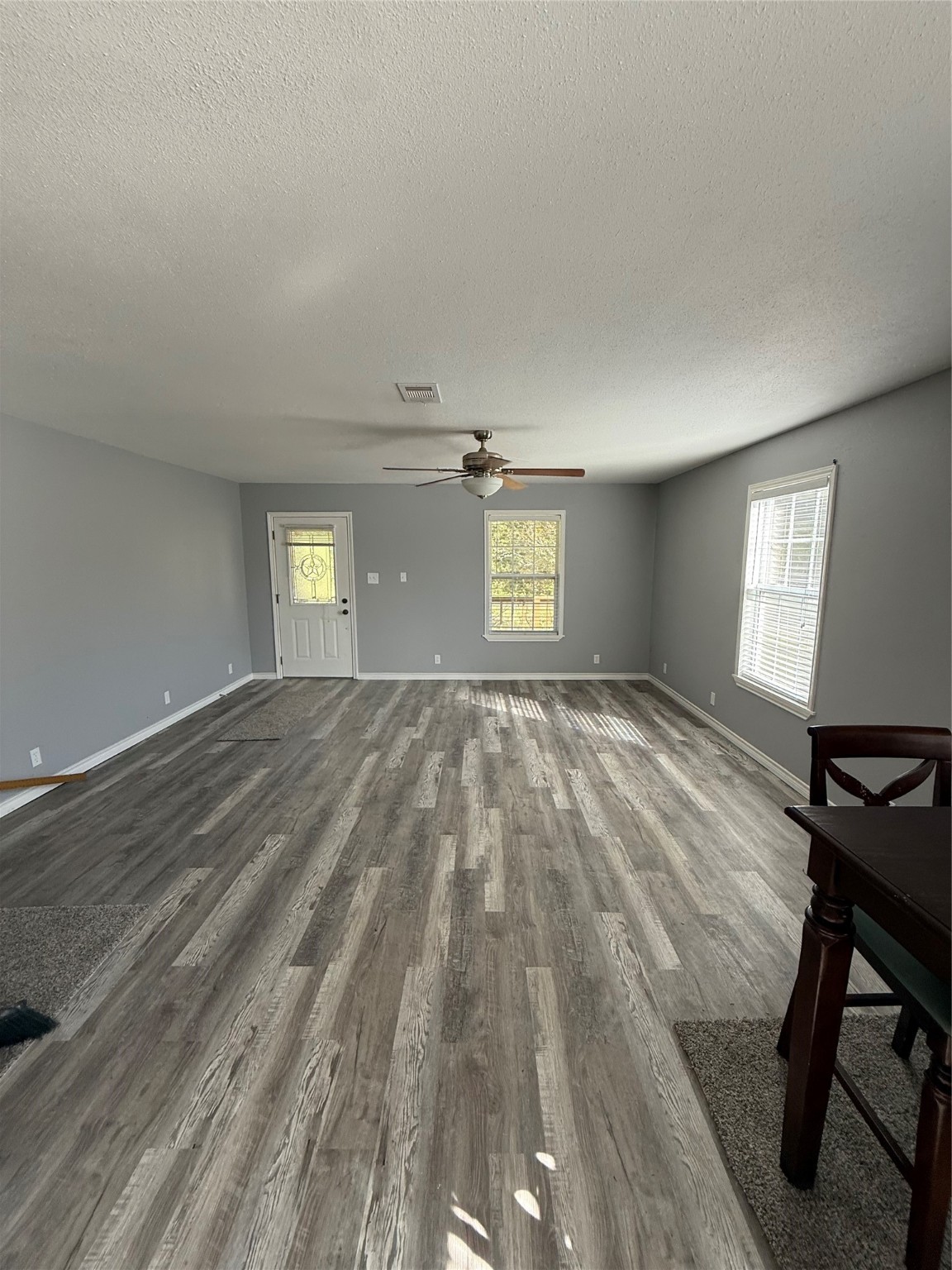 211 North Frances Avenue Shepherd, TX 77371 - Photo 4 of 11 a view of an empty room and window and wooden floor