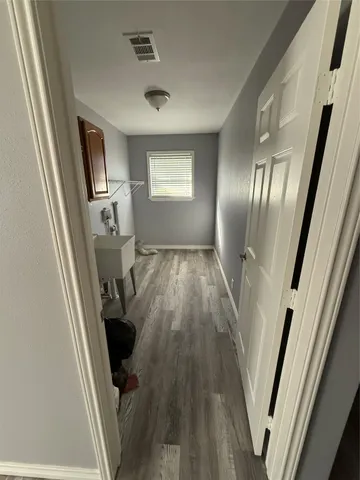 a view of a livingroom with wooden floor and staircase