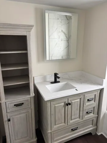 a bathroom with a sink a vanity and mirror