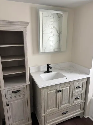 a bathroom with a sink a vanity and a mirror