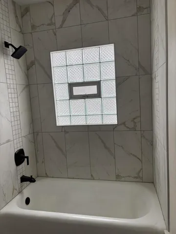 a bathroom with a bathtub and a shower