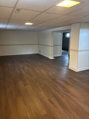 a view of a room with wooden floor