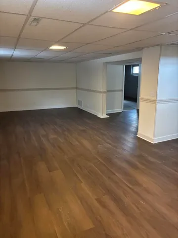 a view of a room with wooden floor