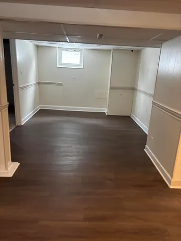 a view of a room with wooden floor