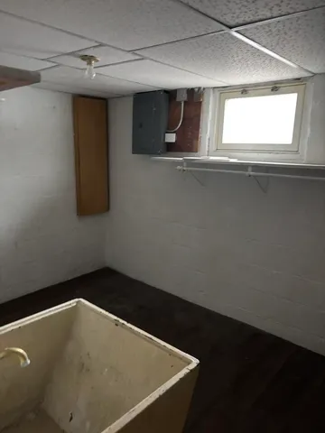 a view of a small space with wooden floor and a window