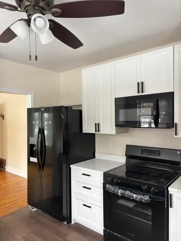 a kitchen with stainless steel appliances kitchen island a refrigerator and a stove