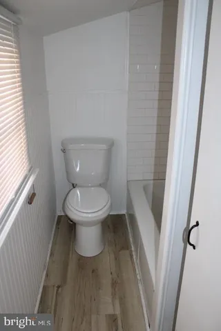 a white toilet sitting next to a sink