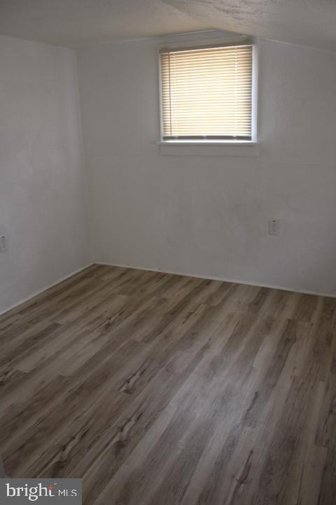 28 East Maple Street Dallastown, PA 17313 - Photo 3 of 7 an empty room with wooden floor and windows
